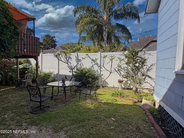 a front view of house with a garden
