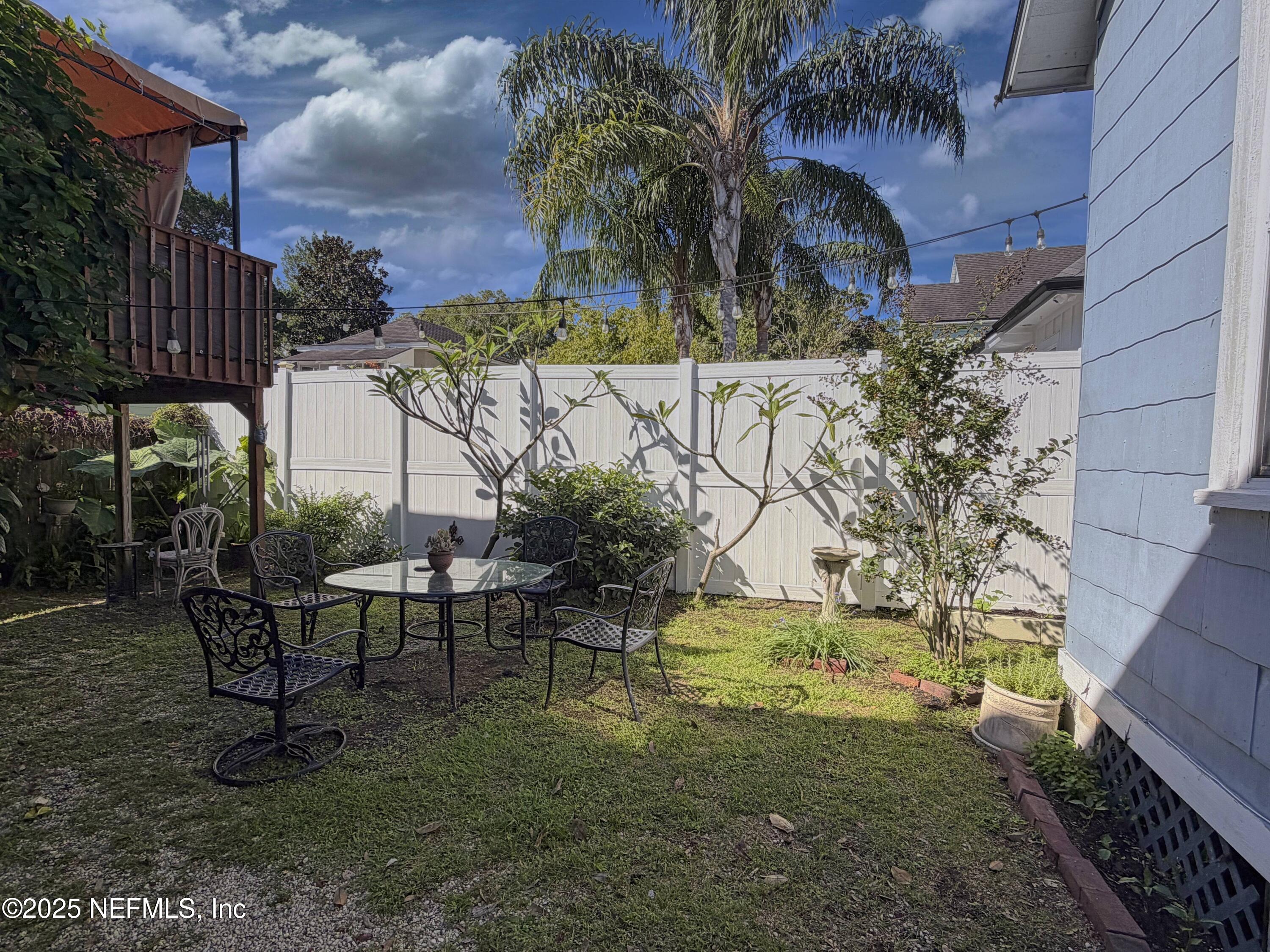 15 Hope Street St. Augustine, FL 32084 - Photo 15 of 16 a view of a patio with table and chairs and potted plants