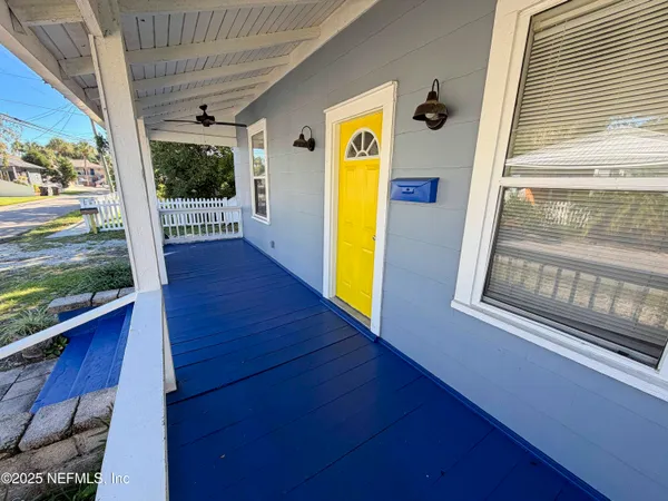 a view of a balcony with wooden floor and door