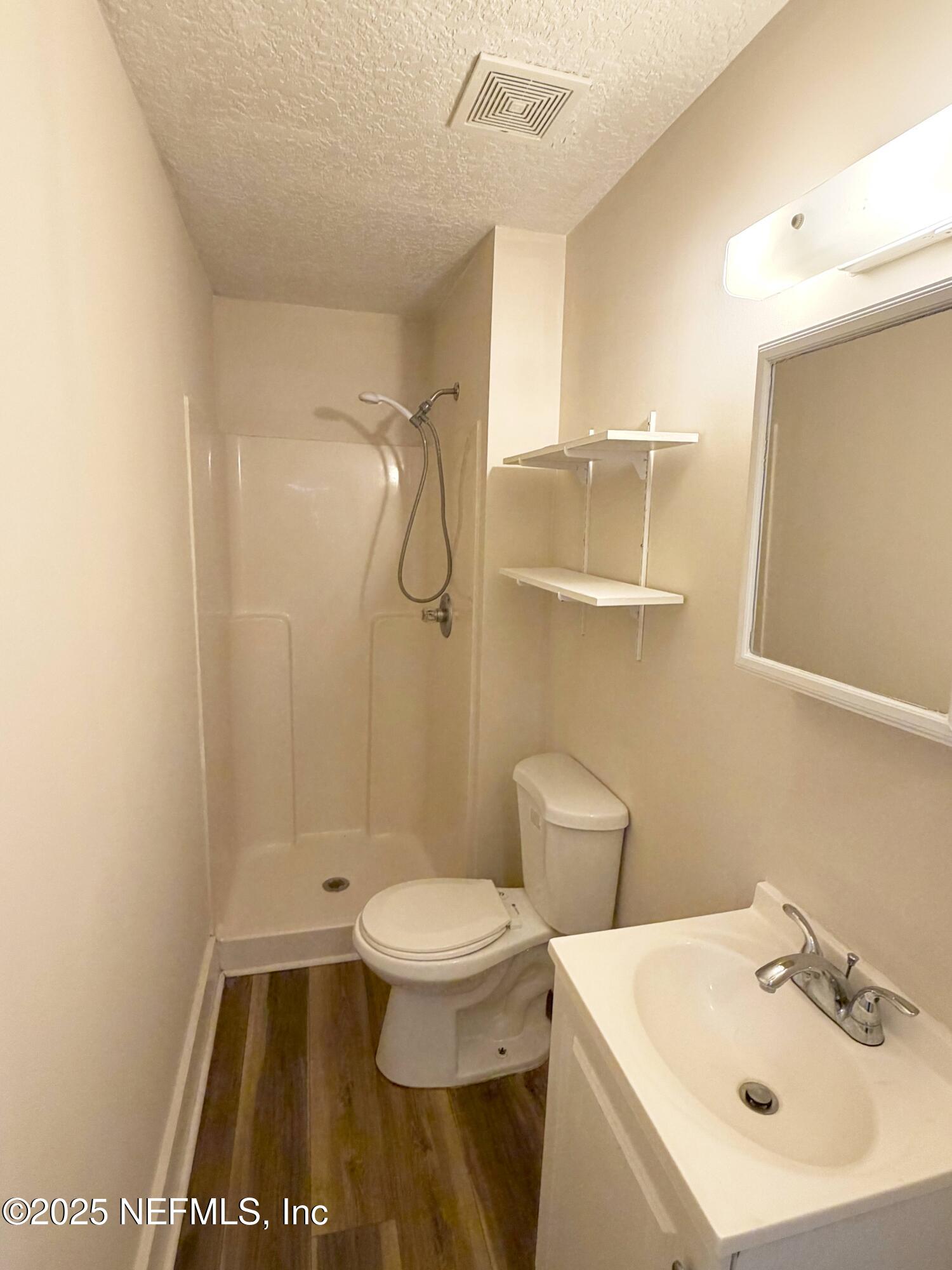 15 Hope Street St. Augustine, FL 32084 - Photo 10 of 16 a bathroom with a sink a toilet and shower