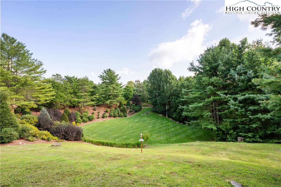 333 Windy Ridge Road Vilas, NC 28692 - Photo 41 of 46 a view of a golf course with a lake