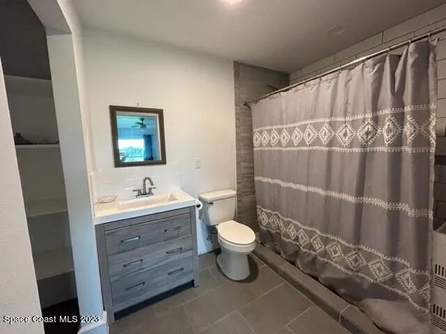 a bathroom with a toilet sink and shower