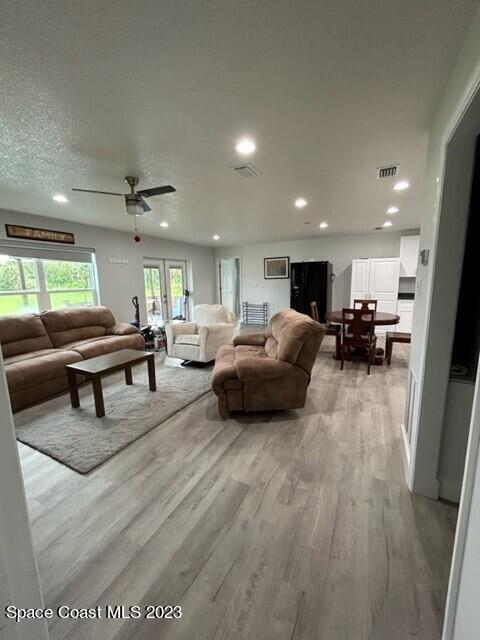 520 Atz Road, Unit COTTAGE Malabar, FL 32950 - Photo 17 of 25 a living room with furniture and a couch