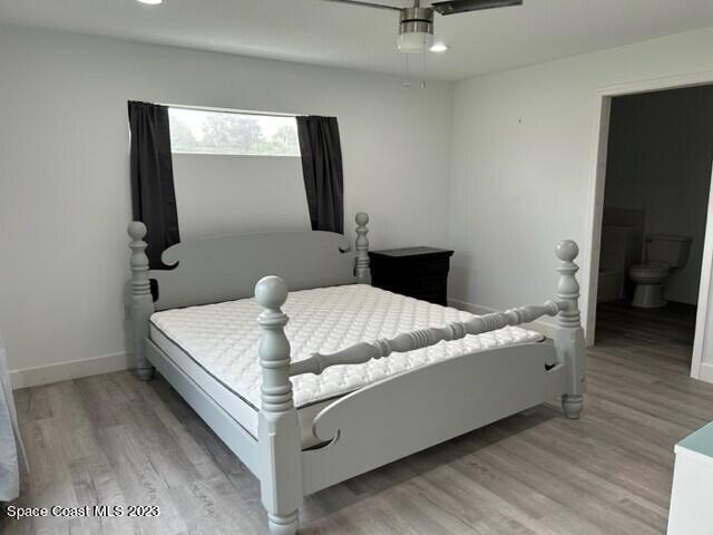 520 Atz Road, Unit COTTAGE Malabar, FL 32950 - Photo 19 of 25 a living room with a bed and a flat screen tv