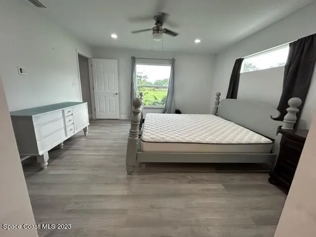 a spacious bedroom with a large bed and a window