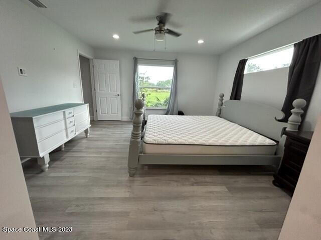 520 Atz Road, Unit COTTAGE Malabar, FL 32950 - Photo 20 of 25 a spacious bedroom with a large bed and a window