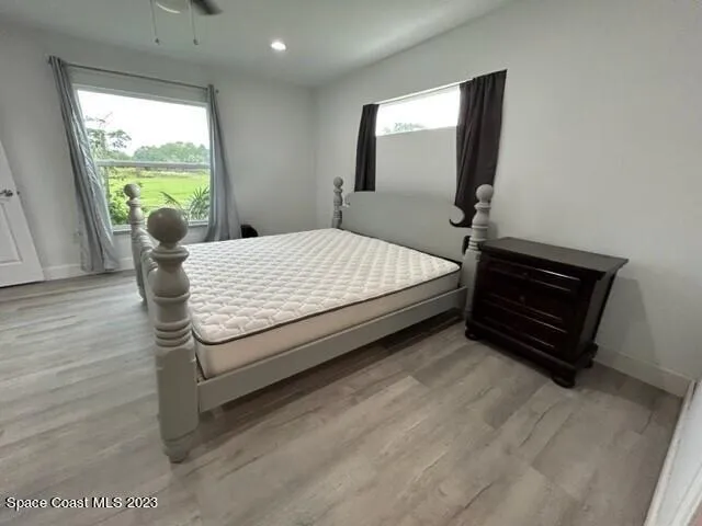 a bed sitting in a bedroom next to a window