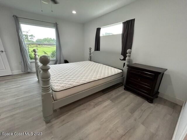 520 Atz Road, Unit COTTAGE Malabar, FL 32950 - Photo 21 of 25 a bed sitting in a bedroom next to a window