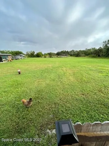a view of a garden with an outdoor seating