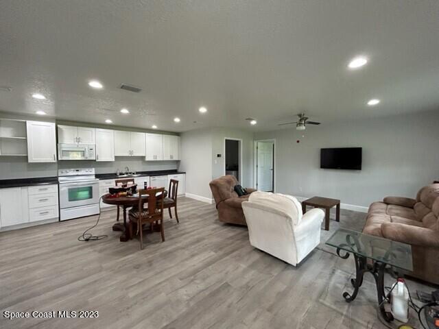 520 Atz Road, Unit COTTAGE Malabar, FL 32950 - Photo 7 of 25 a living room with furniture and a flat screen tv