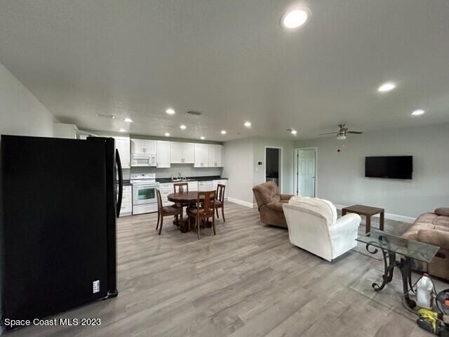 520 Atz Road, Unit COTTAGE Malabar, FL 32950 - Photo 8 of 25 a living room with furniture and a flat screen tv