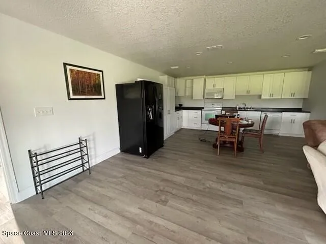 a view of kitchen with furniture and refrigerator