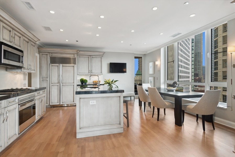 10 East Delaware Place, Unit 21D Chicago, IL 60611 - Photo 13 of 33 a kitchen with sink microwave and stove