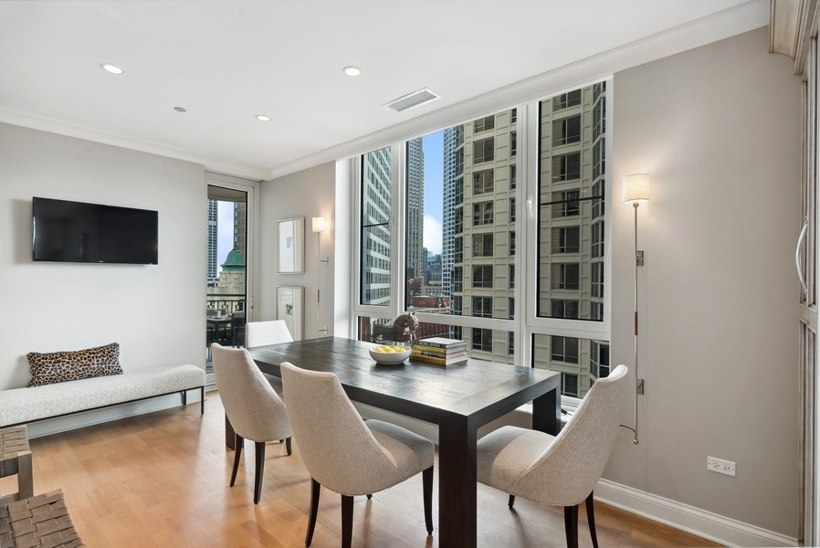 10 East Delaware Place, Unit 21D Chicago, IL 60611 - Photo 14 of 33 a view of a dining room with furniture window and outside view