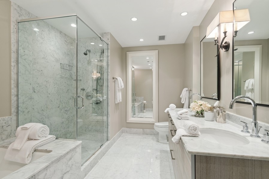 10 East Delaware Place, Unit 21D Chicago, IL 60611 - Photo 20 of 33 a bathroom with a sink double vanity and shower
