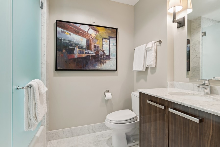 10 East Delaware Place, Unit 21D Chicago, IL 60611 - Photo 23 of 33 a bathroom with a sink vanity and toilet