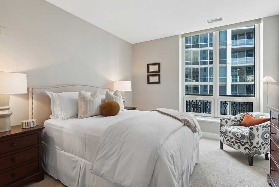 10 East Delaware Place, Unit 21D Chicago, IL 60611 - Photo 24 of 33 a bedroom with a bed and window