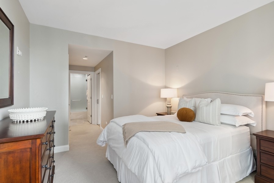 10 East Delaware Place, Unit 21D Chicago, IL 60611 - Photo 25 of 33 a bedroom with a bed and a cabinets