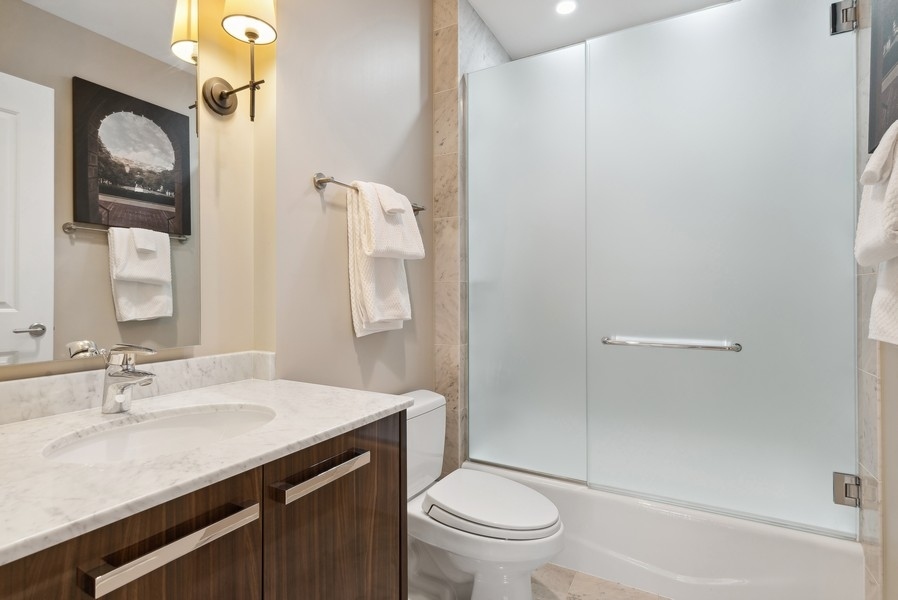 10 East Delaware Place, Unit 21D Chicago, IL 60611 - Photo 26 of 33 a bathroom with a sink a toilet and shower