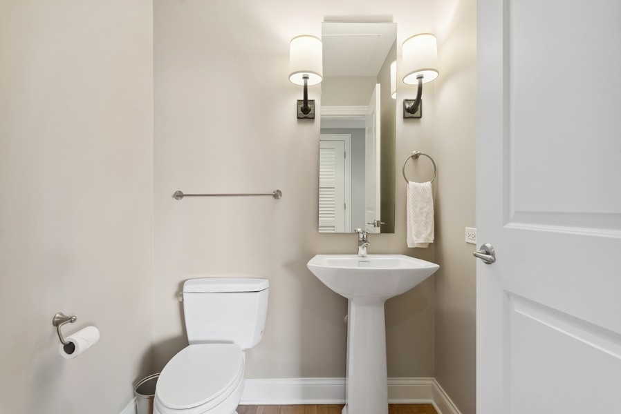 10 East Delaware Place, Unit 21D Chicago, IL 60611 - Photo 27 of 33 a bathroom with a sink a mirror and toilet