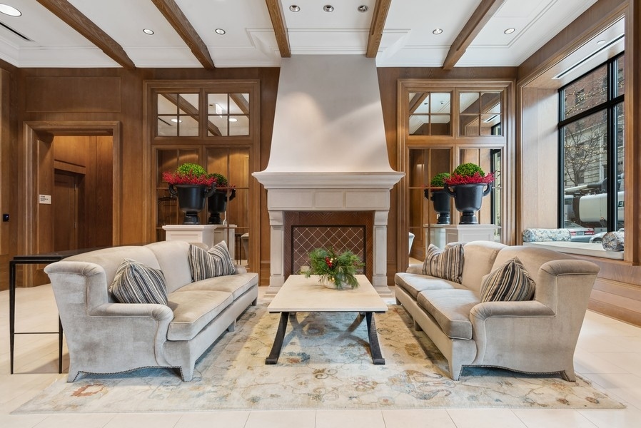 10 East Delaware Place, Unit 21D Chicago, IL 60611 - Photo 3 of 33 a living room with furniture a rug and a fireplace