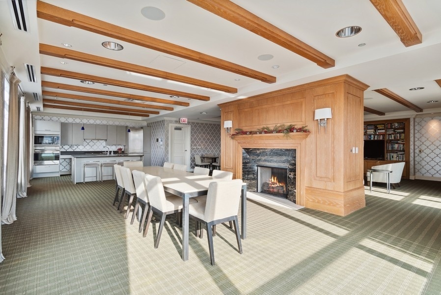 10 East Delaware Place, Unit 21D Chicago, IL 60611 - Photo 32 of 33 a view of a dining room with furniture wooden floor and a chandelier