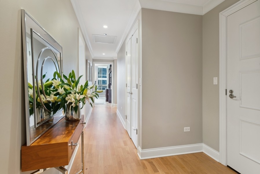 10 East Delaware Place, Unit 21D Chicago, IL 60611 - Photo 4 of 33 a view of a hallway with wooden floor