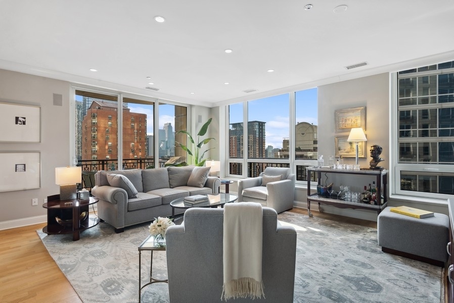 10 East Delaware Place, Unit 21D Chicago, IL 60611 - Photo 7 of 33 a living room with furniture and large windows