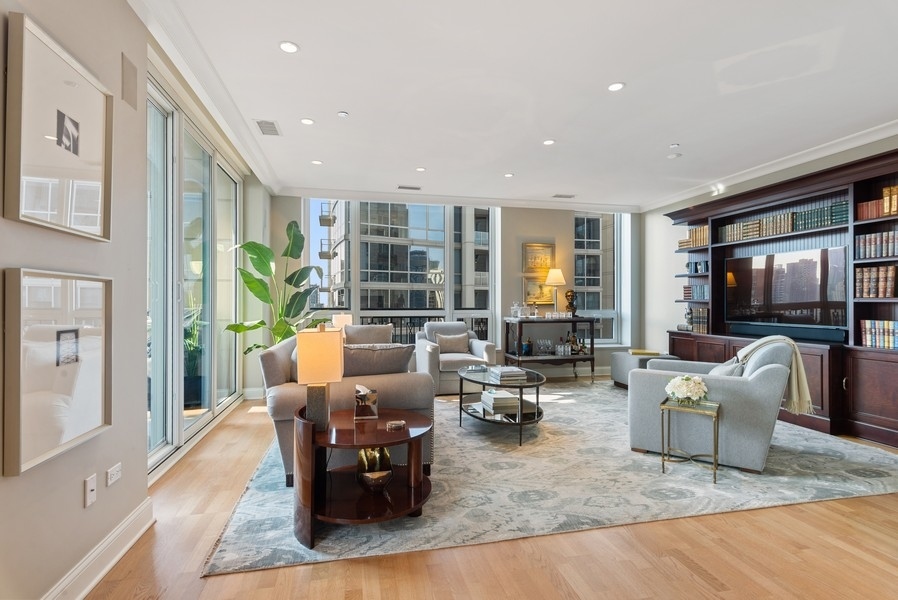 10 East Delaware Place, Unit 21D Chicago, IL 60611 - Photo 8 of 33 a living room with fireplace furniture and a flat screen tv