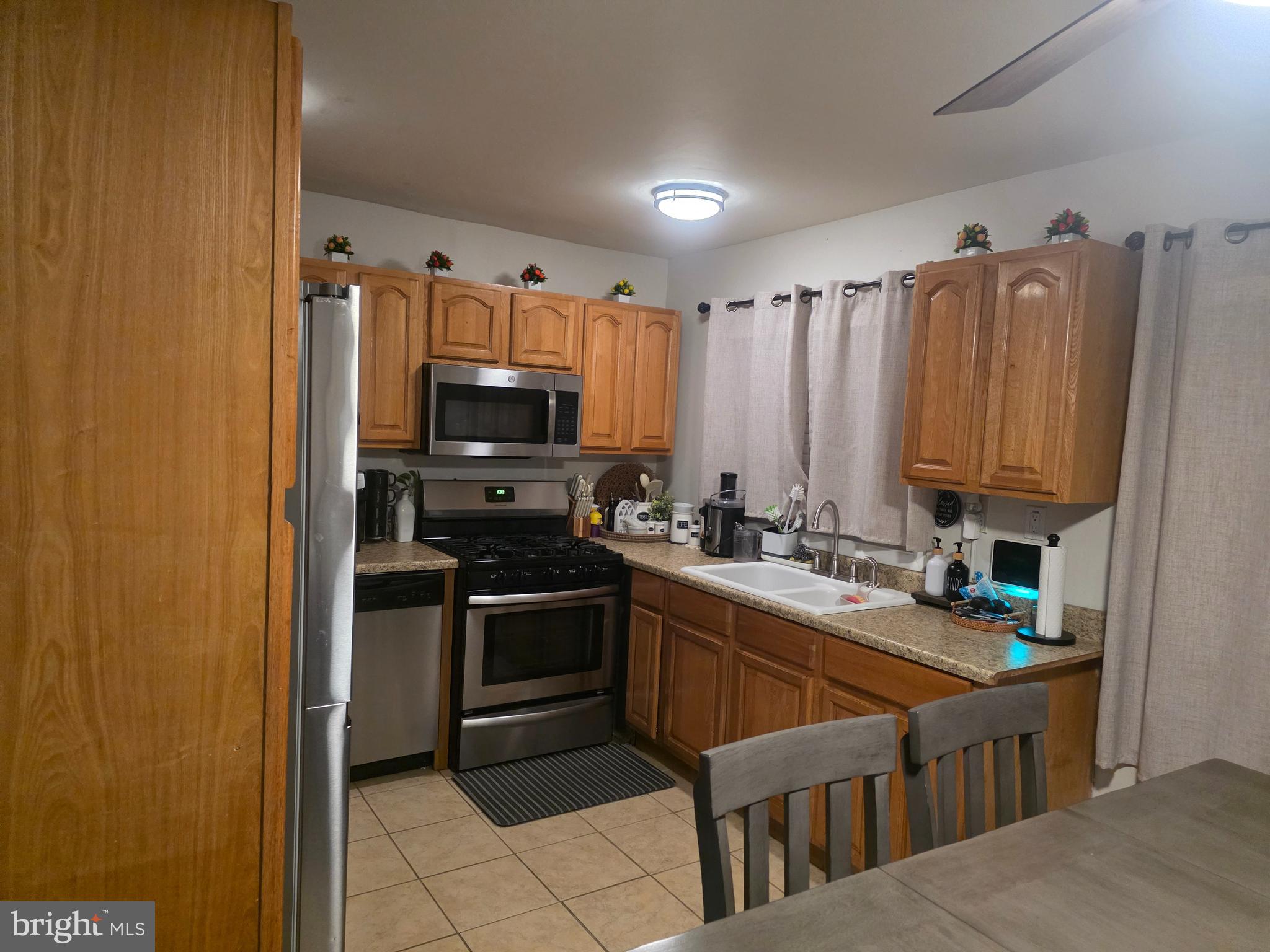 44 Peacock Lane Willingboro, NJ 08046 - Photo 6 of 23 a kitchen with stainless steel appliances a stove sink and microwave
