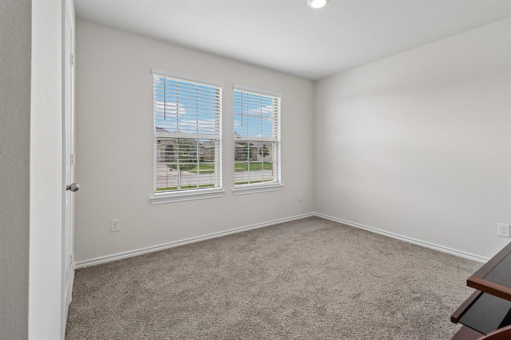 1453 Millstead Rill Road Caddo Mills, TX 75135 - Photo 15 of 40 Room featuring two windows with horizontal blinds, neutral-toned carpeting, white baseboards, and a recessed ceiling light