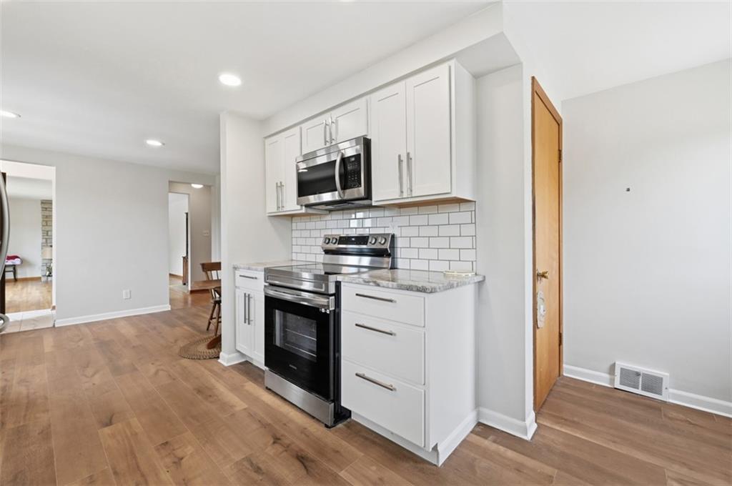 6 Greenview Drive McKees Rocks, PA 15136 - Photo 26 of 44 a kitchen with stainless steel appliances granite countertop a stove a sink and a microwave