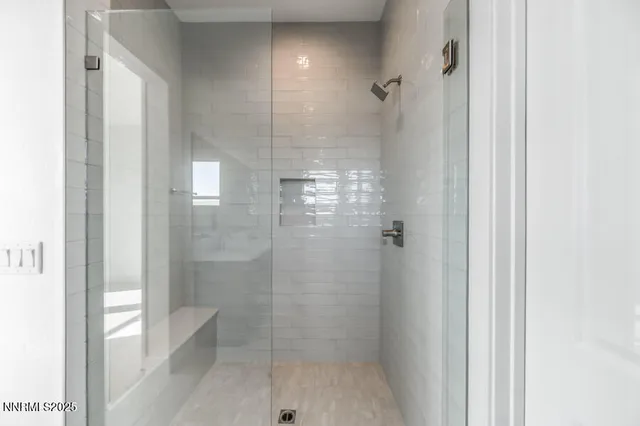 a bathroom with a glass shower door