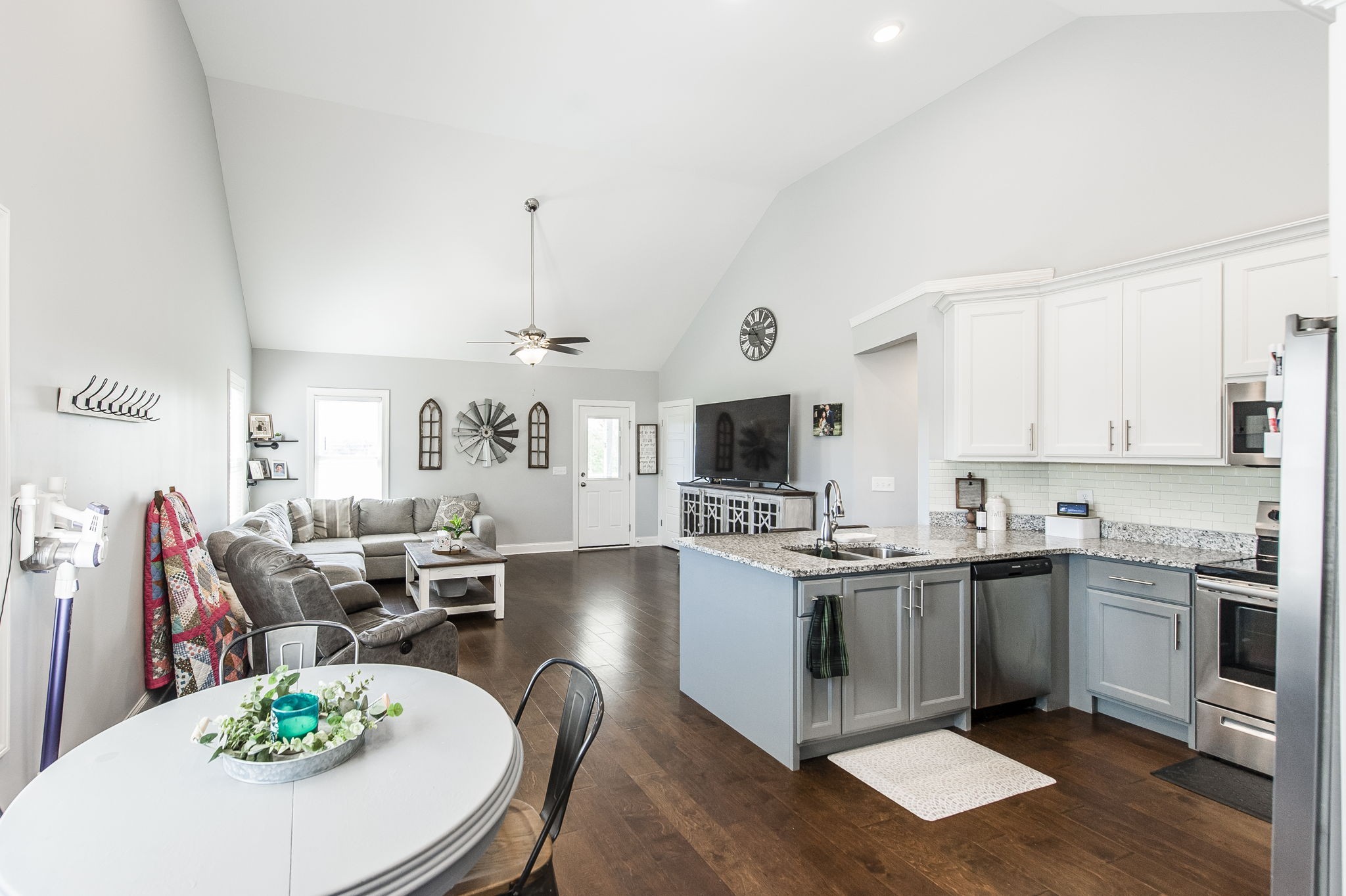 1261 Friendship Road Cross Plains, TN 37049 - Photo 19 of 47 a open kitchen with stainless steel appliances kitchen island granite countertop a stove a sink a dining table and chairs with wooden floor