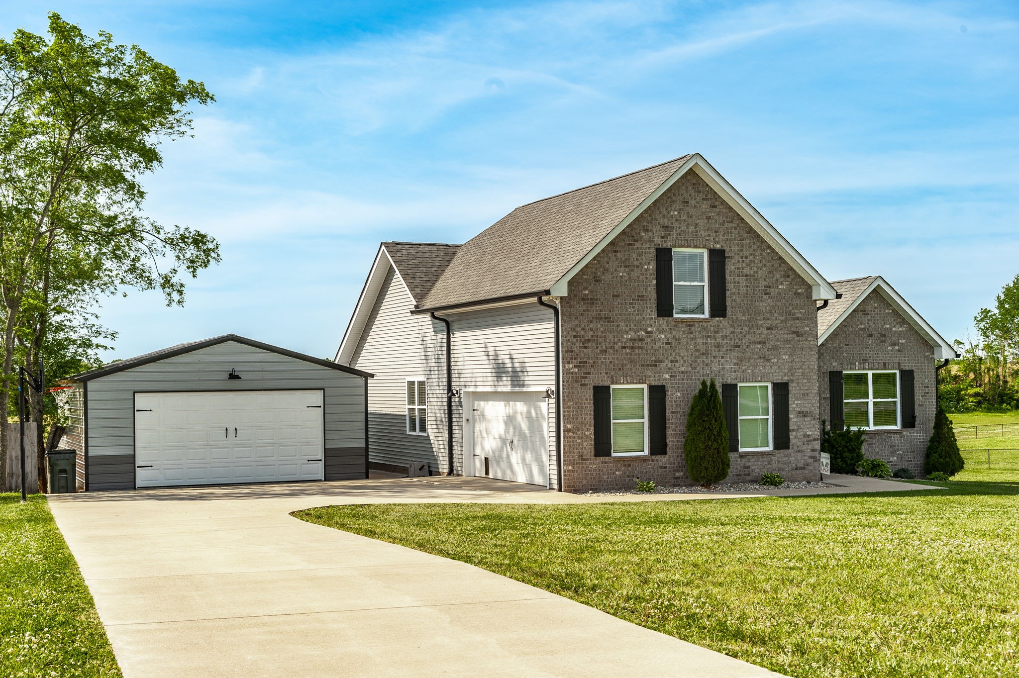 1261 Friendship Road Cross Plains, TN 37049 - Photo 2 of 47 a front view of a house with a yard and garage