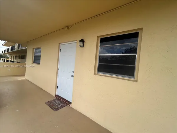 a kitchen with granite countertop a refrigerator stove and sink