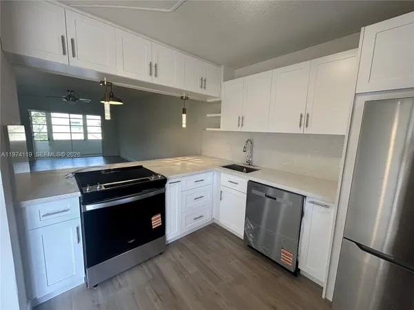 a bathroom with a granite countertop sink mirror vanity and toilet
