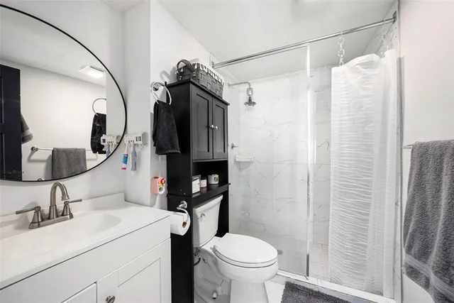 a bathroom with a sink toilet and shower