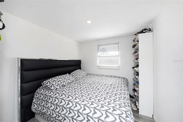 a bedroom with a bed and a window