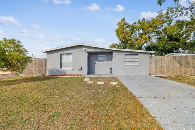 a view of a house with a yard and garage