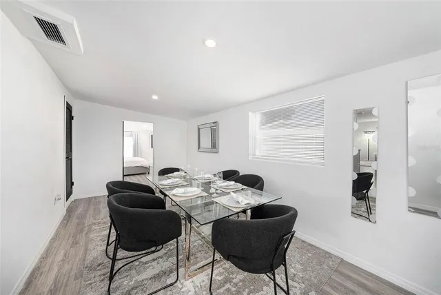 a dining room with furniture and window