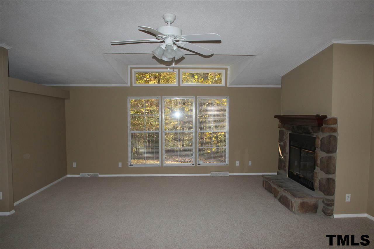 265 Heritage Road Roxboro, NC 27574 - Photo 2 of 13 Large family room with fireplace and new carpet and paint