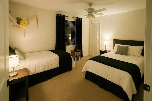 a bedroom with bed and wooden floor