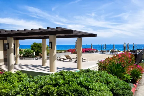 a view of a chairs and table in swimming pool