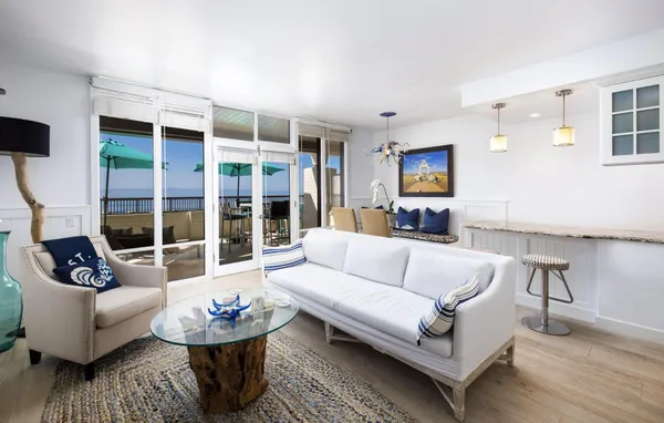 a living room with furniture a flat screen tv and a large window