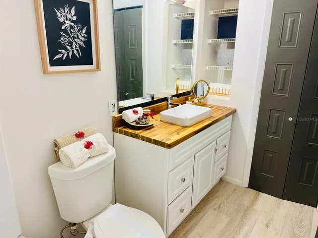a bathroom with a toilet sink and mirror