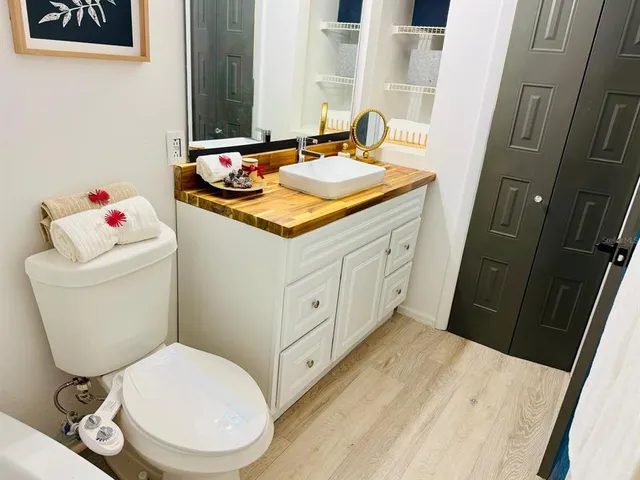 a bedroom with a bed and a painting on the wall