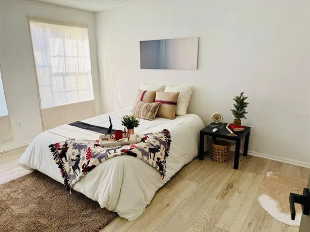 a bedroom with a bed and window