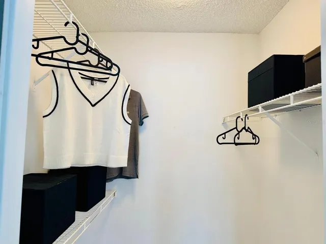 a bed sitting in a bedroom next to a window with a dresser