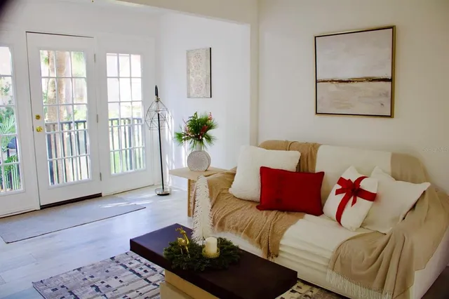 a living room with furniture or couch and a potted plant